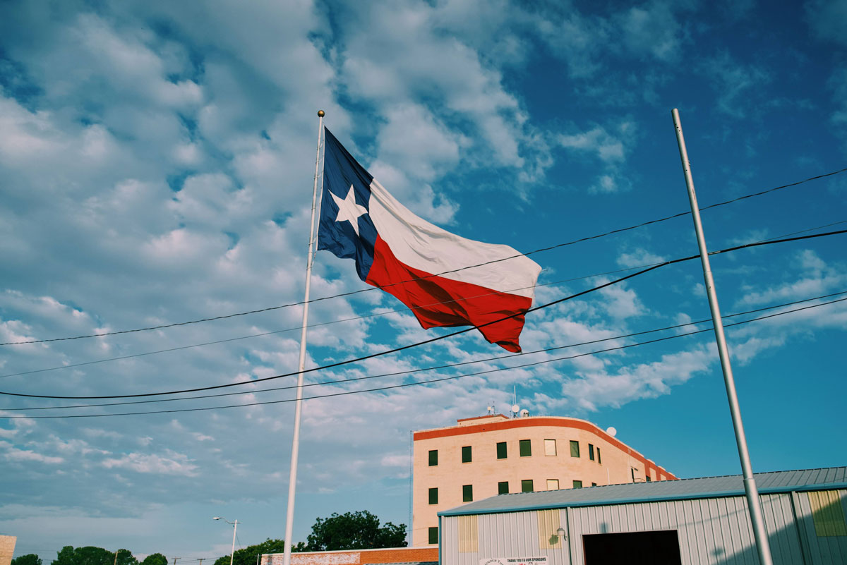 Texas Flag waving over the city of Odessa, Texas